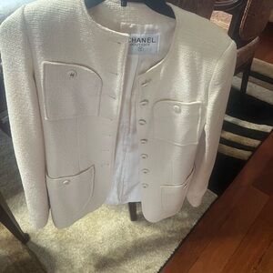 Chanel Women's cream boucle jacket featuring four patch pockets